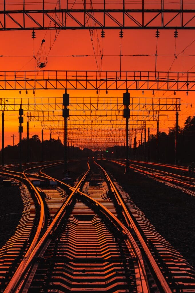 Dark Silhouettes Railway Infrastructure In Dramatic Sunset Backl